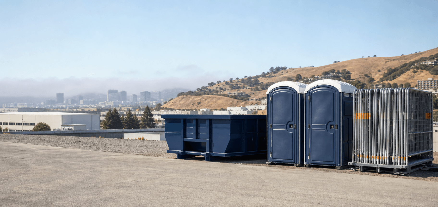 Portable restrooms, a roll-off dumpster, and temporary fencing ready for delivery